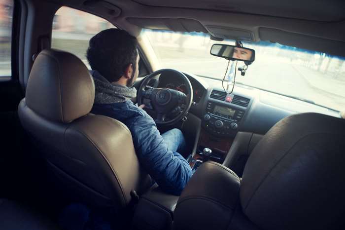 Man driving a car on a road