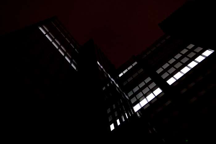 Dark building with illuminated windows