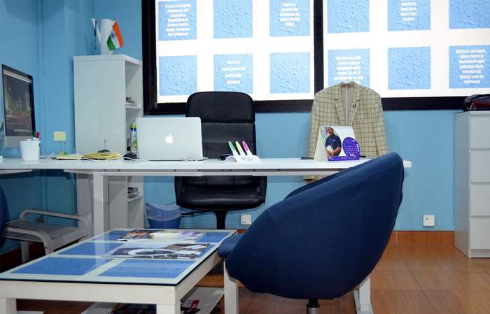 Office desk with Apple laptop and Indian flag