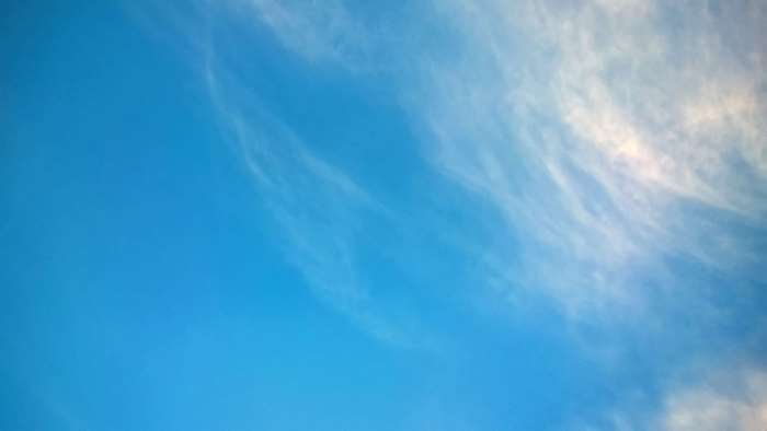 Blue sky with wispy white clouds 4K