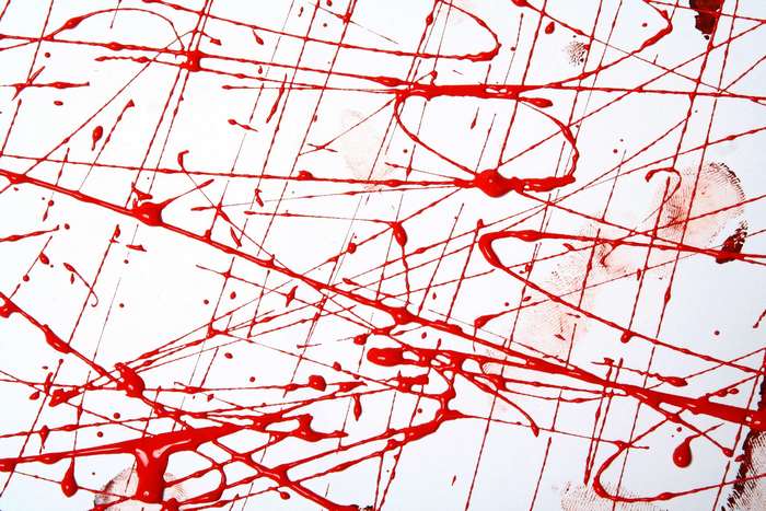 Red paint splatters and lines on a white background