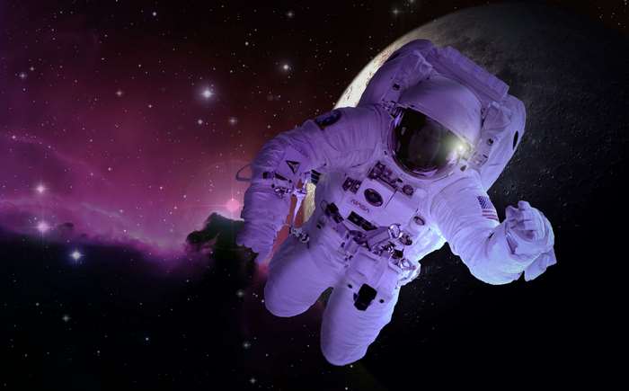 Astronaut floating in space with nebula and moon