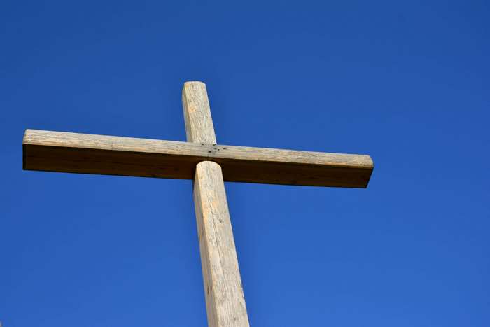 Wooden cross against a blue sky