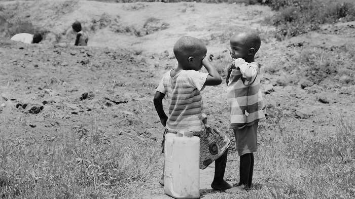 Children in rural Uganda with water jug