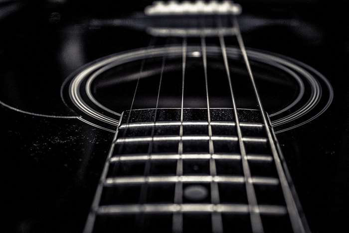 Close-up of an acoustic guitar fretboard and strings