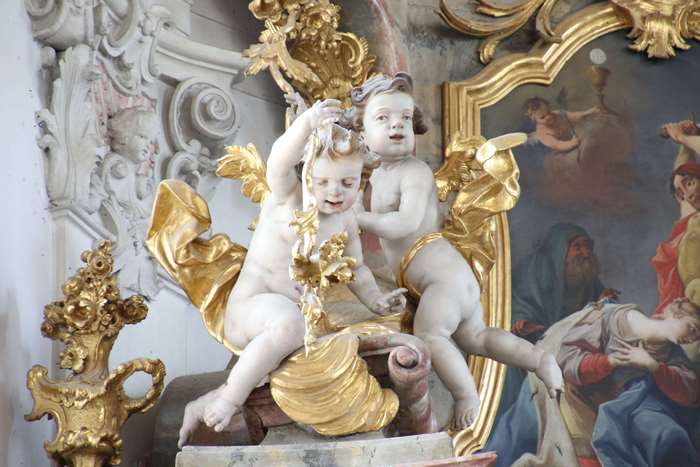 Marble cherubs with golden decorations in a church