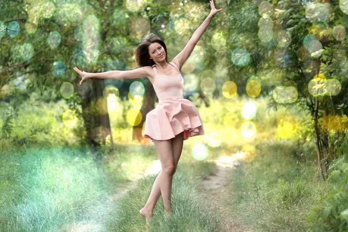 Girl in pink dress dancing in nature 4K