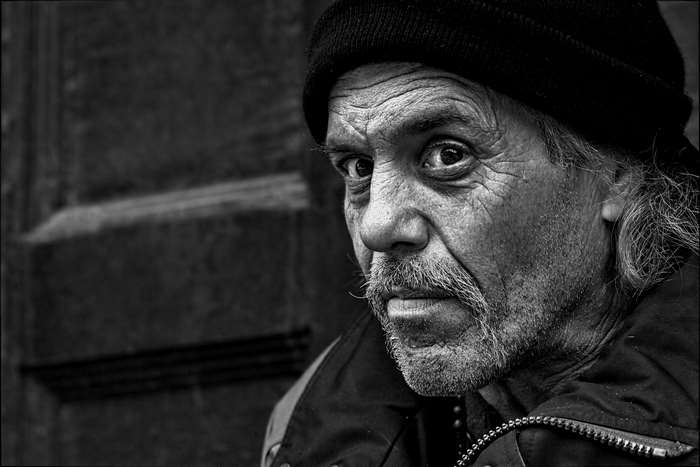 Close up of an elderly man with wrinkles and a beanie