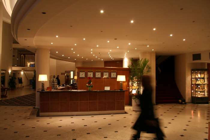 Hotel lobby with reception desk and clocks