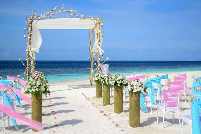 Beach Wedding Ceremony Setup with Floral Decorations
