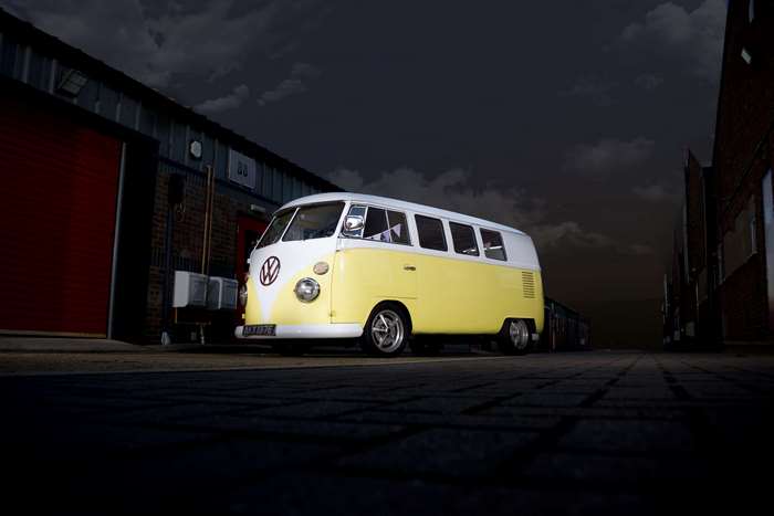 Yellow and white Volkswagen Kombi van at night
