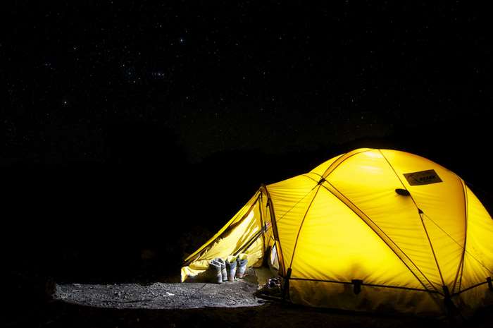 Yellow tent under starry night sky 4K