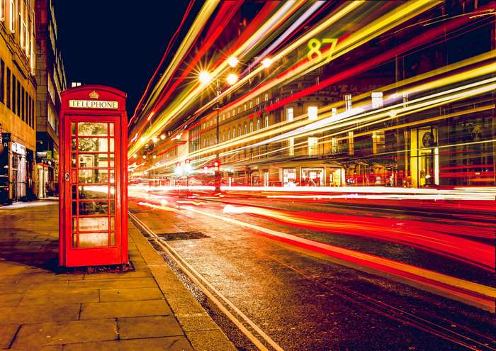 London red telephone booth with light trails at night