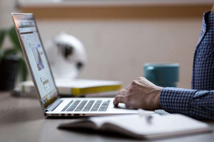 Person typing on a laptop at a desk