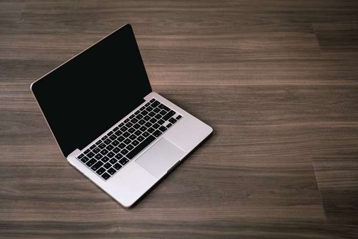 Silver MacBook Pro on a wooden table