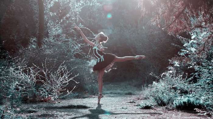 Ballerina dancing in a forest path 4K