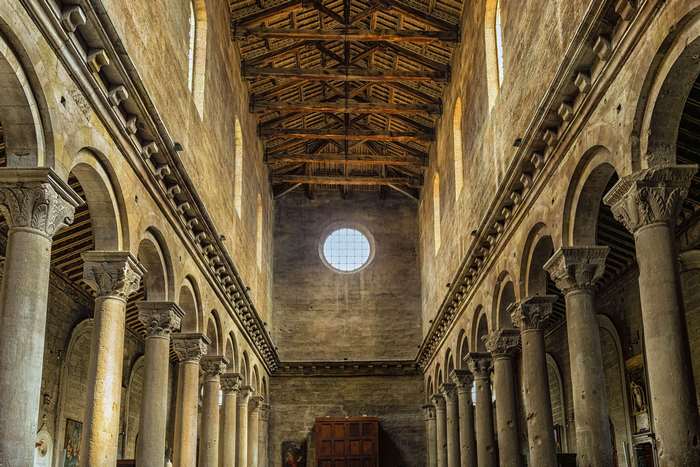 Interior of a Romanesque church with columns and wooden ceiling