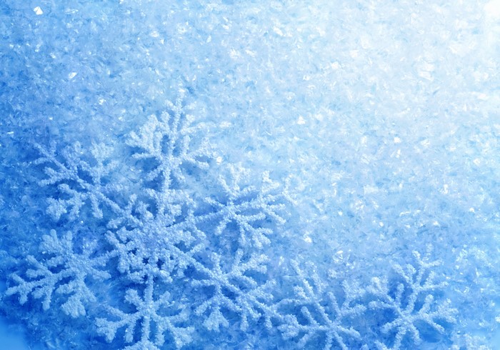 Close-up of artificial snowflakes on a bed of glitter