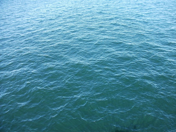 Blue water surface with small waves