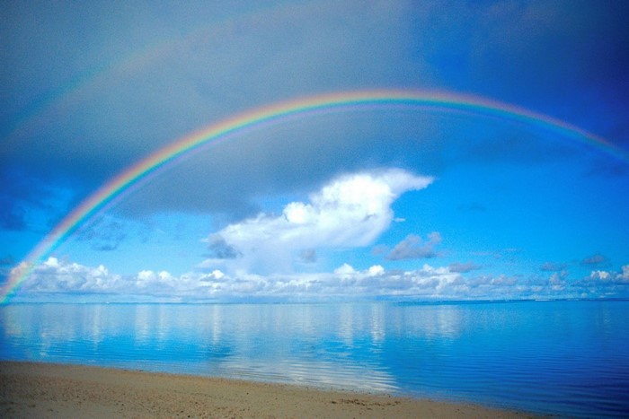 Rainbow over the sea after rain