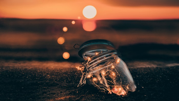 Jar with lights at sunset