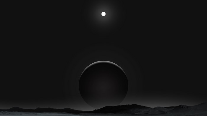 Dark planet with moon over rocky terrain
