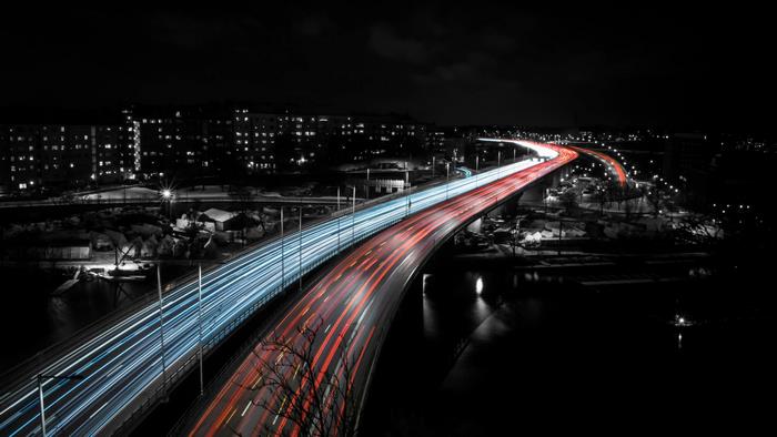 Long exposure highway bridge at night with light trails