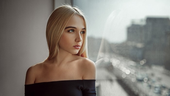 Portrait of a Pensive Blonde Woman by the Window
