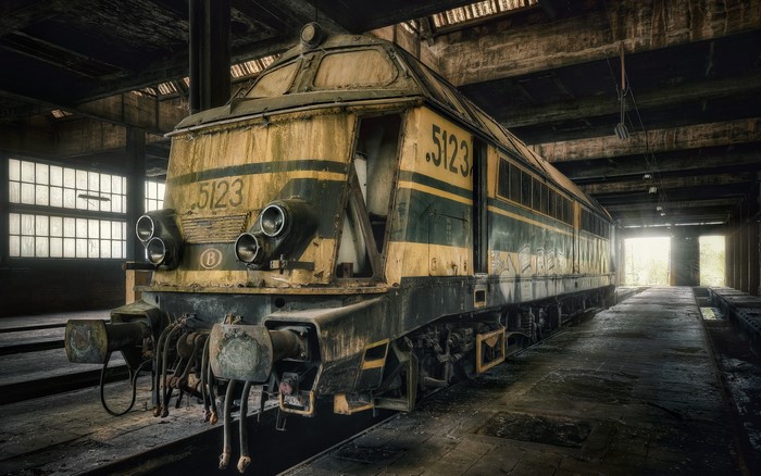 Old abandoned train in a dusty train shed