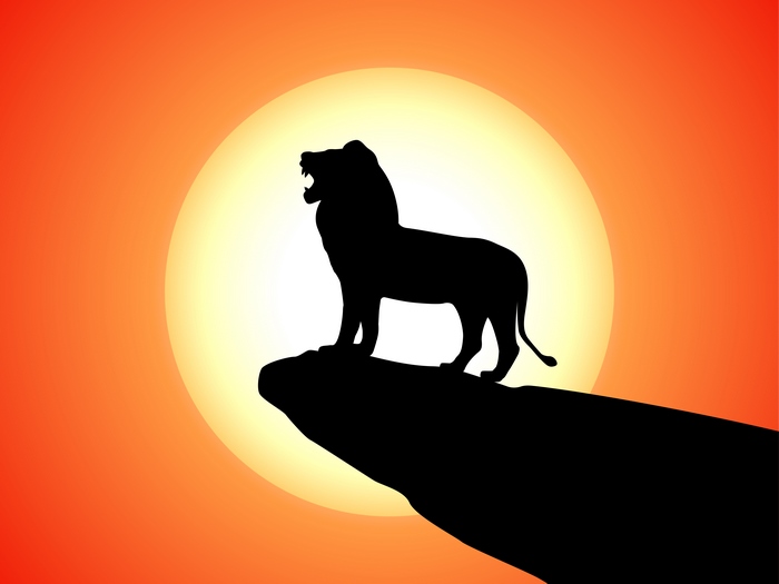 Simba from The Lion King roaring on a cliff at sunset