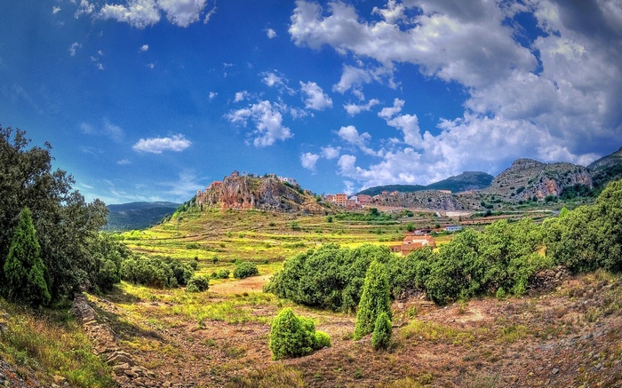 Village on a hill with terraced fields and trees