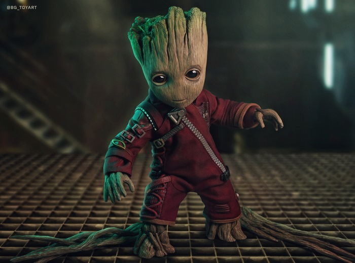 Baby Groot in Red Suit Standing on Metal Grid