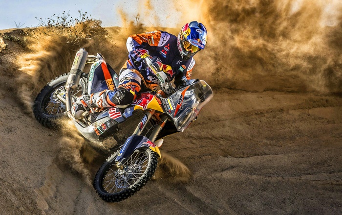 Motocross rider on a KTM motorcycle kicking up dirt