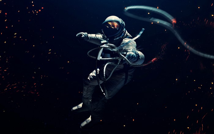 Astronaut floating in space with sparks