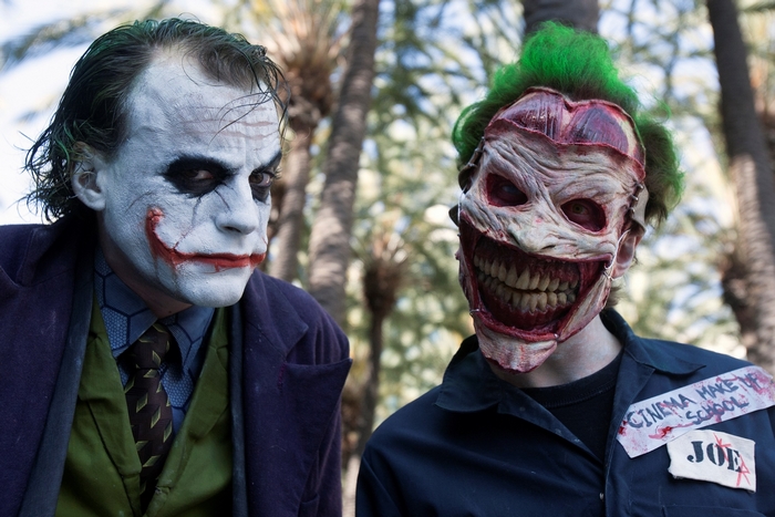 Two Jokers, one masked, one in makeup