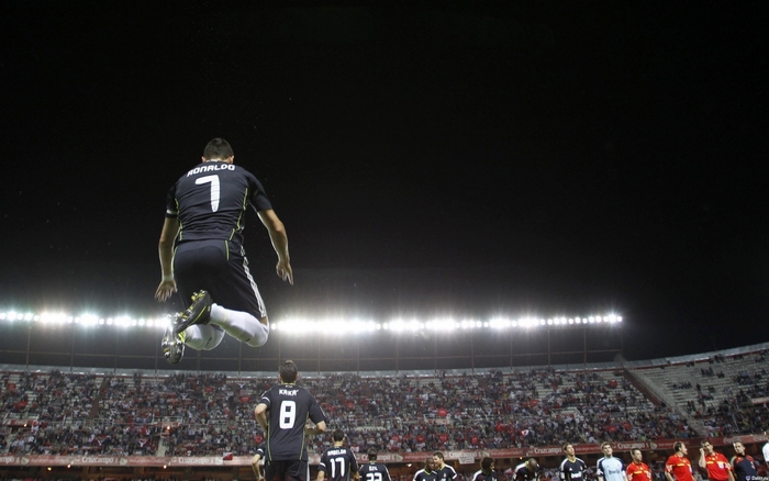 Cristiano Ronaldo jumping in a football stadium