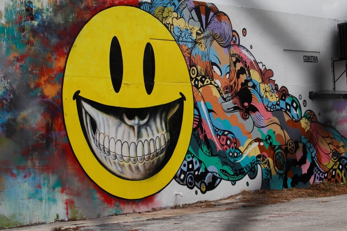 Graffiti mural with smiley face and colorful abstract art