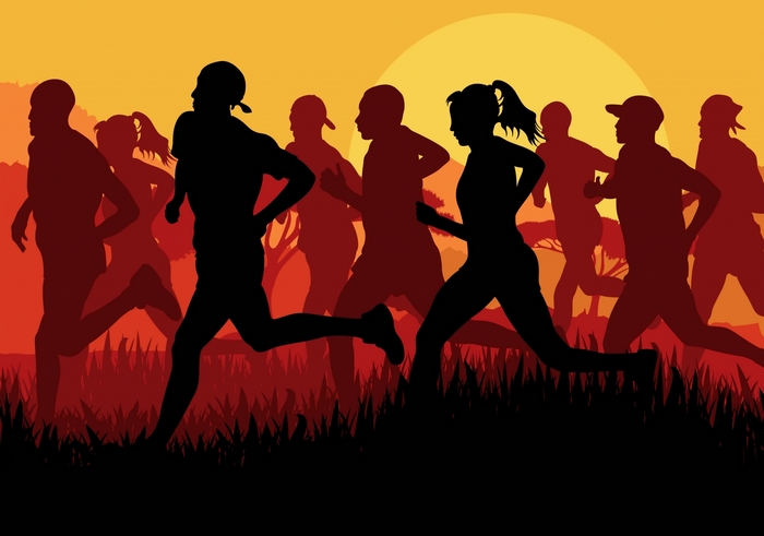 Silhouettes of runners in a race at sunset