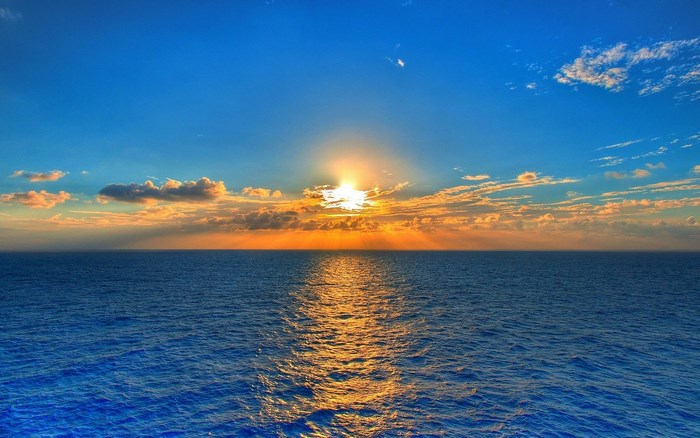 Sunset over the ocean with clouds