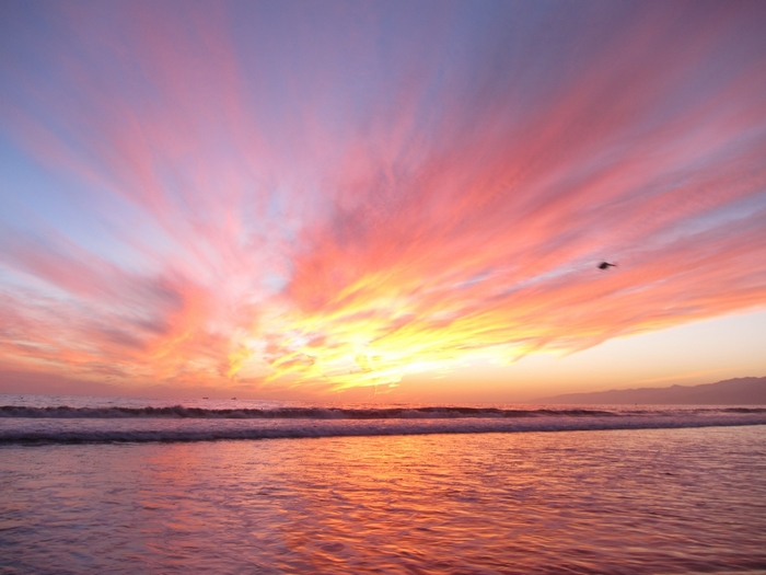 Sunset over the ocean with colorful clouds