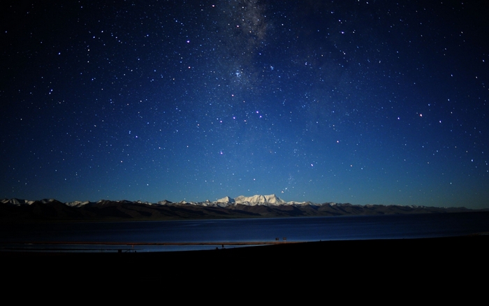 Night sky over mountains and lake