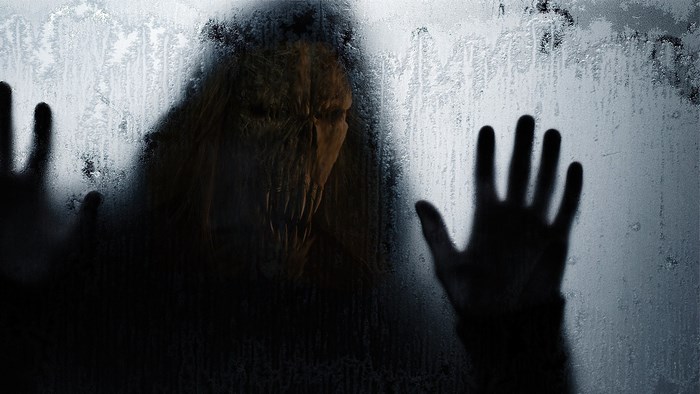 Scary monster behind frosted glass