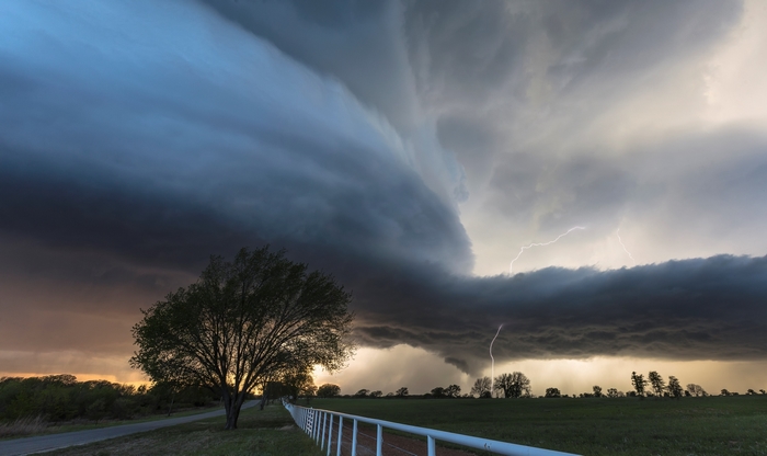 Tornado storm with lightning over a field