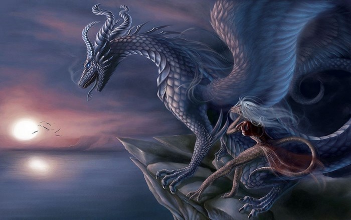 Dragon and woman on a cliff at sunset