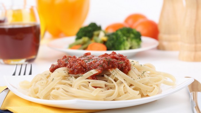 Pasta with tomato sauce and side of vegetables