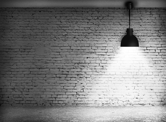Minimalist Lit Brick Wall with Industrial Lamp