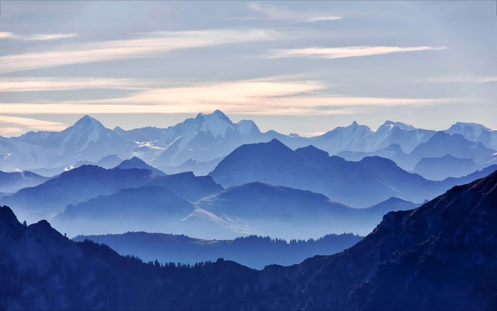Layered Blue Mountains Under a Cloudy Sky