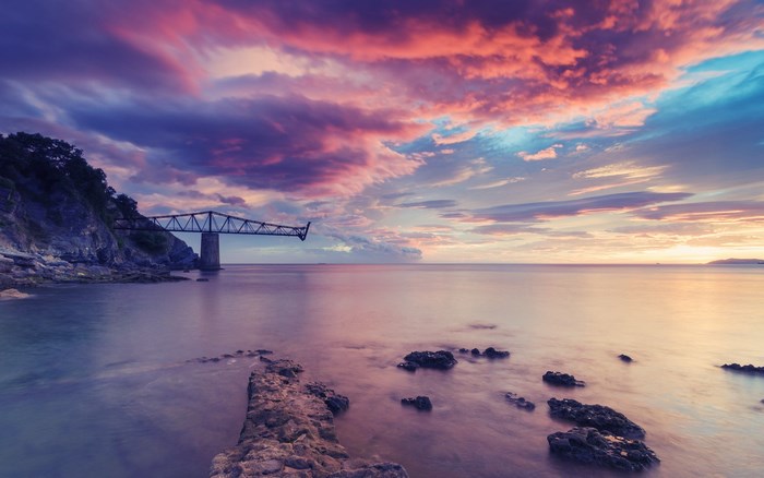 Bridge over the sea at sunset