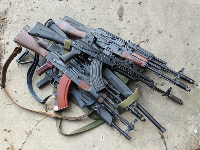 Cluster of AK-47 Rifles on Concrete Floor