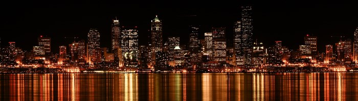 City skyline at night with water reflection